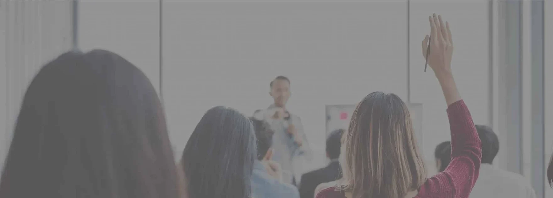 meeting room with an employee raising their hand