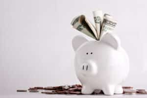 One stuffed, overfilled full piggy bank